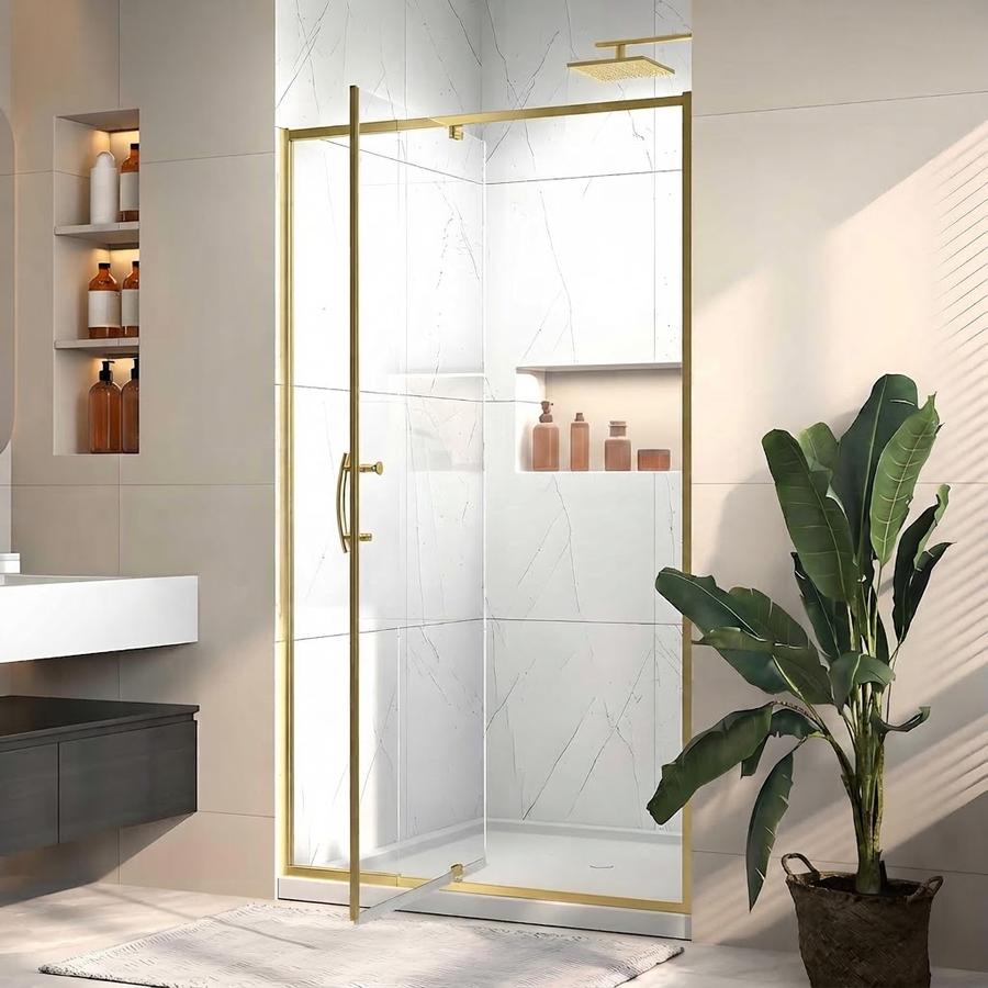 Brushed gold pivot shower door in a finished tiled alcove